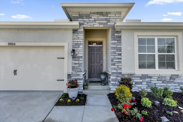 view of exterior entry with a garage