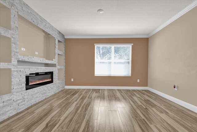 unfurnished living room with crown molding, hardwood / wood-style floors, and a fireplace