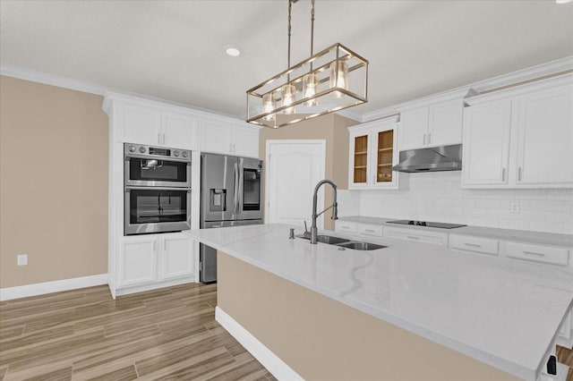 kitchen featuring sink, a center island with sink, white cabinets, and appliances with stainless steel finishes