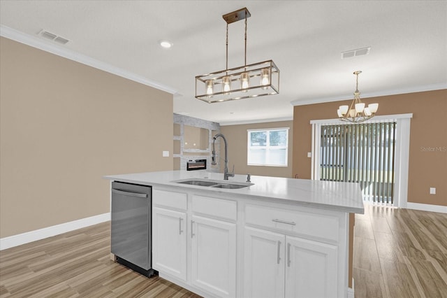 kitchen with decorative light fixtures, dishwasher, sink, white cabinets, and a kitchen island with sink