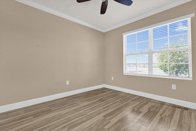 empty room with hardwood / wood-style flooring, ornamental molding, and ceiling fan