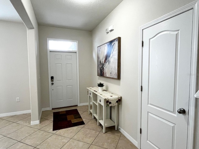 entryway with light tile patterned flooring