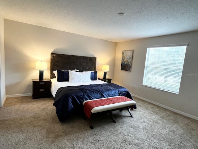 bedroom featuring carpet floors and a textured ceiling