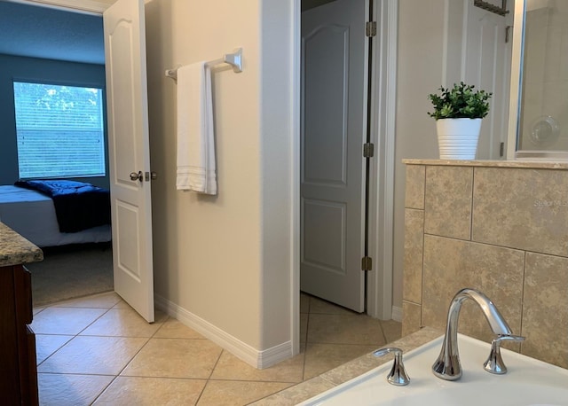 bathroom featuring vanity, a bathing tub, and tile patterned flooring