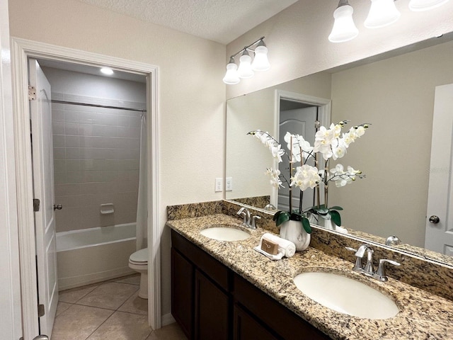 full bathroom featuring shower / bath combination with curtain, tile patterned flooring, vanity, toilet, and a textured ceiling