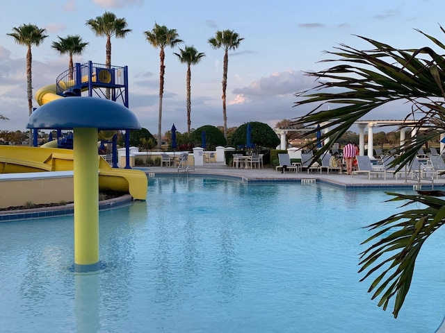 view of pool featuring a water slide and a patio area