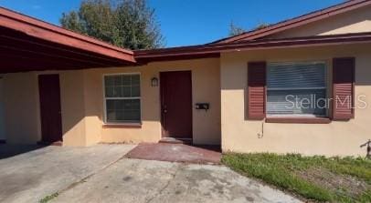 doorway to property with a patio area