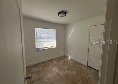 empty room with light tile patterned flooring