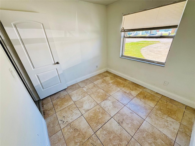 spare room featuring baseboards