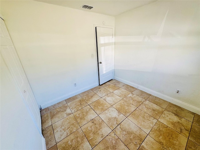 empty room featuring light tile patterned floors, baseboards, and visible vents