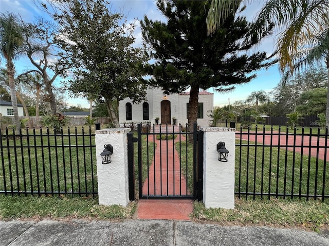 view of gate with a yard