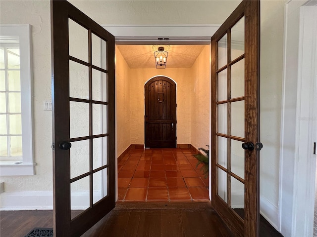 hallway featuring french doors and dark wood-type flooring