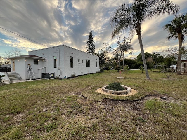 exterior space featuring cooling unit and a fire pit