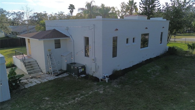 exterior space with a yard and central AC