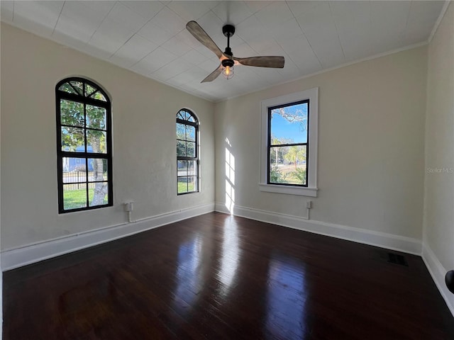 spare room with ceiling fan, ornamental molding, and dark hardwood / wood-style floors