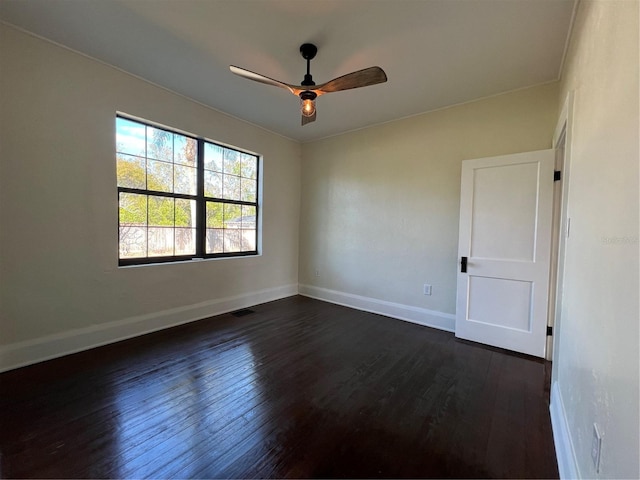 spare room featuring ceiling fan and dark hardwood / wood-style flooring