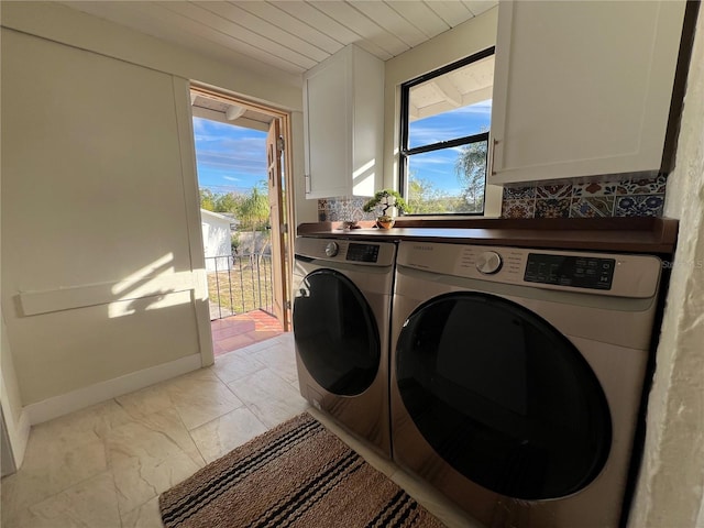 washroom featuring wood ceiling, cabinets, and washing machine and dryer