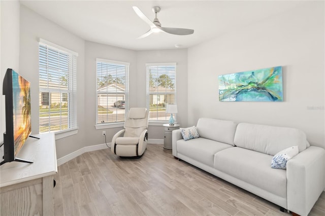 living room with ceiling fan and light wood-type flooring