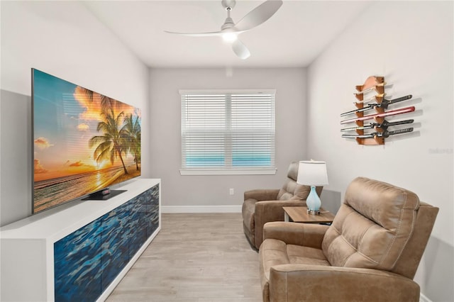 sitting room with ceiling fan and light hardwood / wood-style flooring