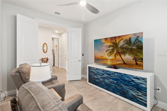 living area with ceiling fan and light wood-type flooring