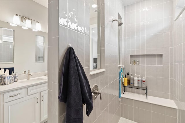 bathroom with vanity and tiled shower