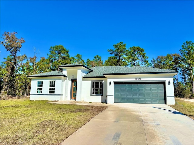 view of front of house featuring a garage and a front lawn