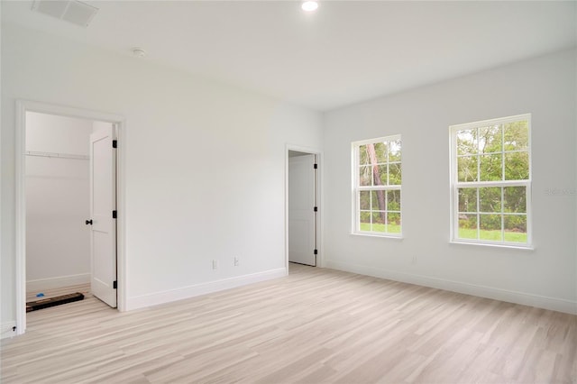 spare room featuring visible vents, recessed lighting, light wood-style flooring, and baseboards