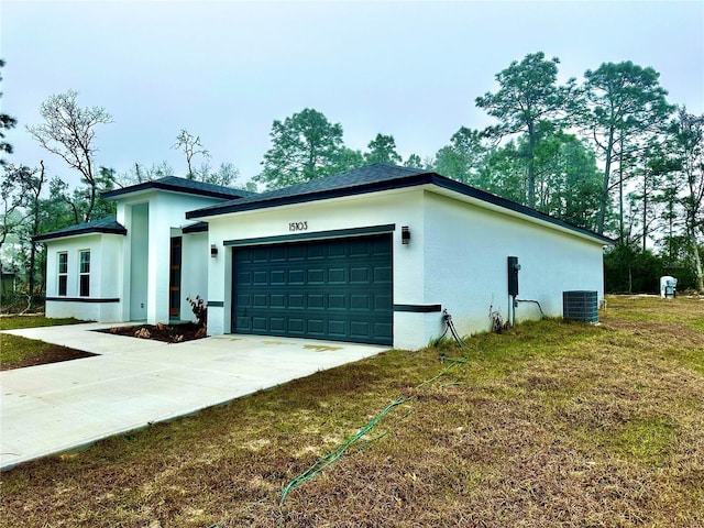 view of side of property featuring a yard, stucco siding, concrete driveway, a garage, and cooling unit