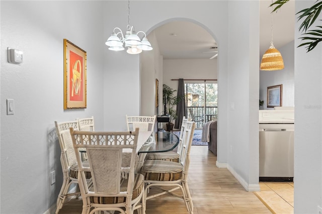 dining space featuring a notable chandelier and light hardwood / wood-style floors