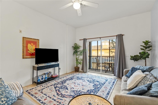 living room featuring ceiling fan and light hardwood / wood-style floors