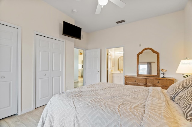 bedroom with ensuite bathroom, ceiling fan, and light hardwood / wood-style flooring