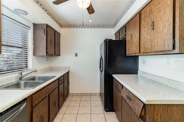 kitchen with light tile patterned flooring, sink, black fridge, stainless steel dishwasher, and ceiling fan