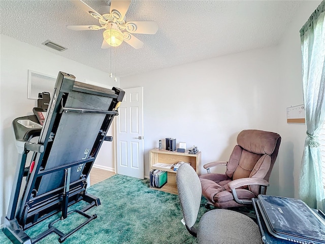 interior space with ceiling fan and a textured ceiling