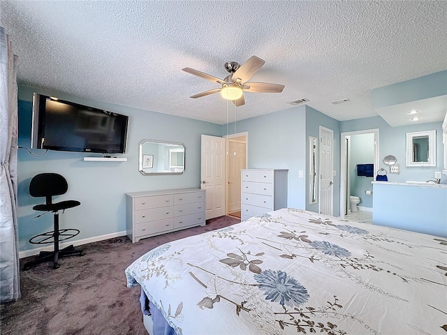 bedroom featuring ceiling fan, connected bathroom, carpet, and a textured ceiling