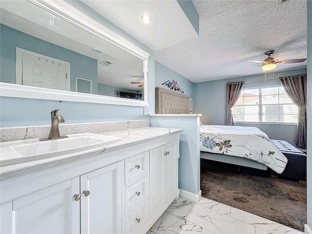 bathroom featuring vanity, a textured ceiling, and ceiling fan