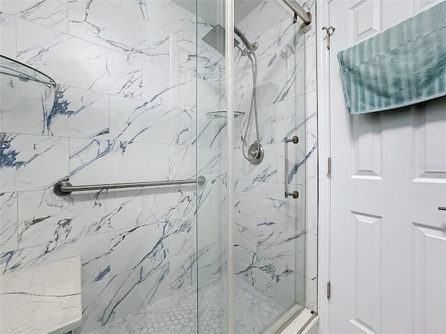 bathroom featuring a shower with shower door