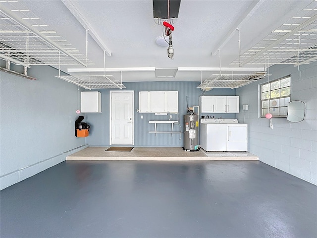 garage featuring washer and clothes dryer and water heater