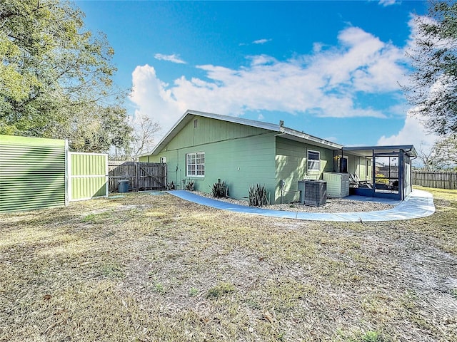 back of house with central AC unit