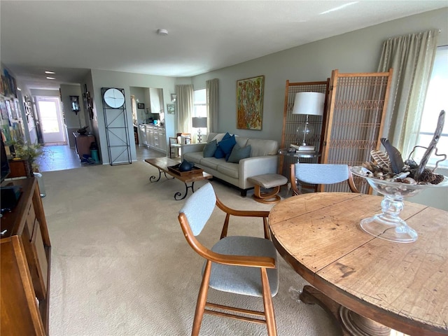 living room featuring light carpet and a healthy amount of sunlight