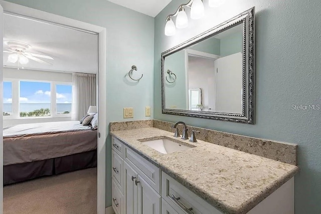 bathroom with ceiling fan and vanity