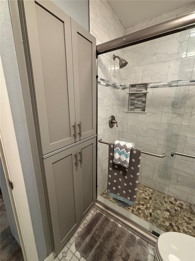 bathroom featuring toilet and walk in shower