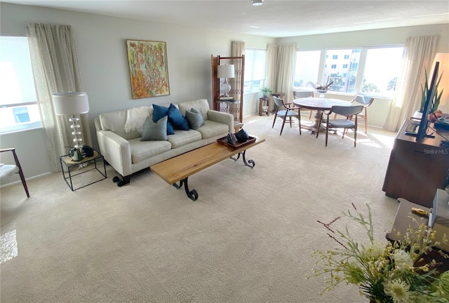 500 The Esplanade N Unit 405, Venice, FL 34285 - carpeted living room featuring plenty of natural light