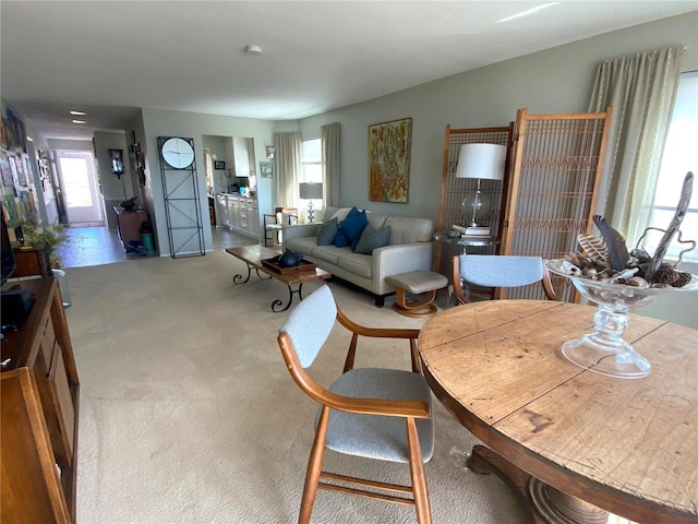 500 The Esplanade N Unit 405, Venice, FL 34285 - carpeted living area featuring a healthy amount of sunlight