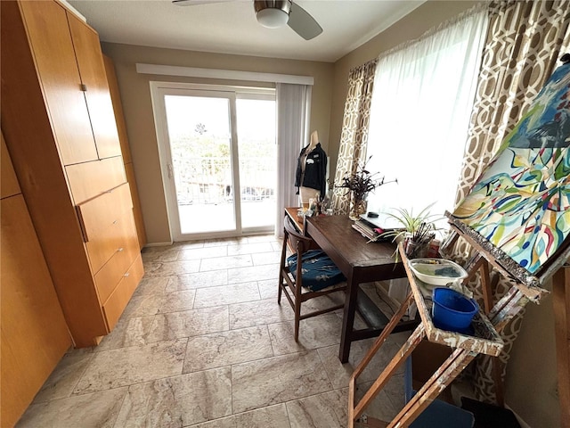 500 The Esplanade N Unit 405, Venice, FL 34285 - home office with ceiling fan and stone tile flooring