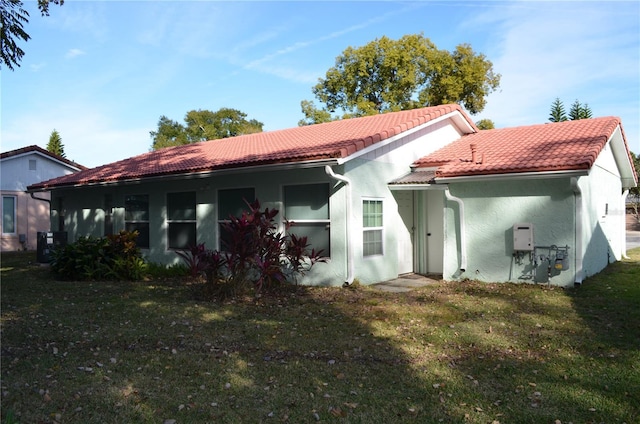 rear view of property with a lawn