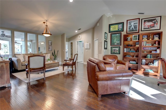 living area with visible vents, lofted ceiling, and dark wood finished floors