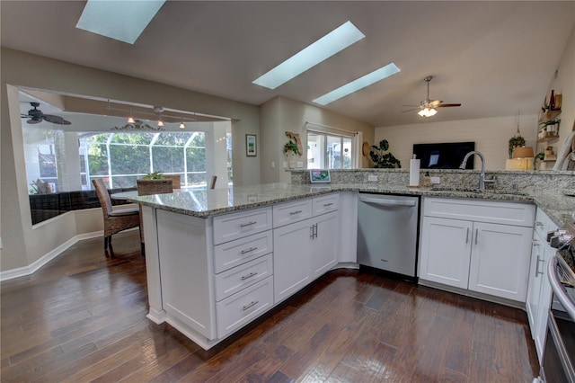 kitchen featuring a sink, dark wood-type flooring, white cabinetry, and stainless steel appliances