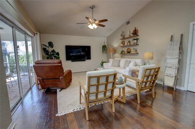 living area featuring a ceiling fan, visible vents, wood finished floors, baseboards, and high vaulted ceiling