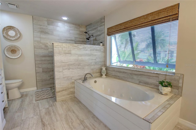 bathroom featuring visible vents, baseboards, walk in shower, toilet, and a whirlpool tub