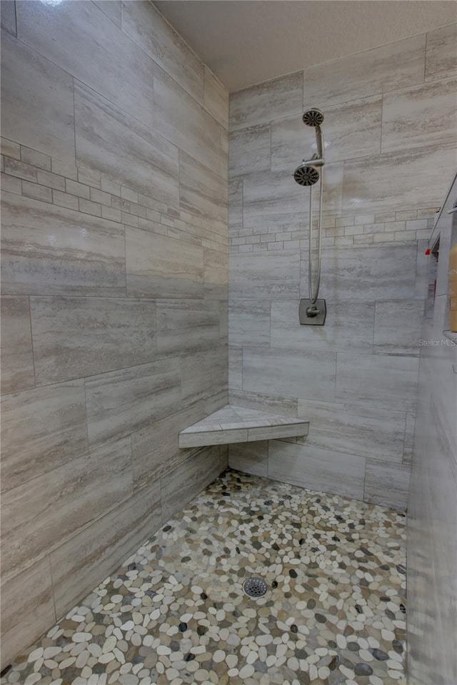 bathroom with tiled shower